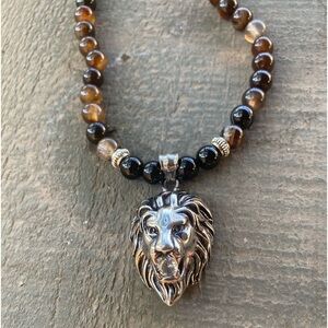 Black onyx and brown Tiger eyes w/ silver spacers….solid lion head pendant.